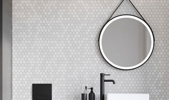 Black Trimmed Bathroom Mirror hung on a Grey Tiled Wall