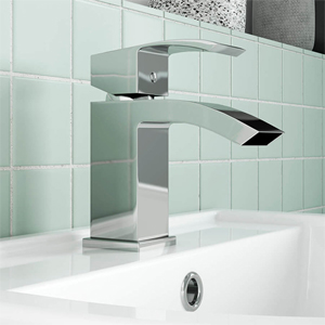 Chrome Nuie bathroom sink tap on a white ceramic tiled backdrop.