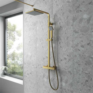 Brass coloured Shower Valve and Shower Head on a grey ceramic tile surround