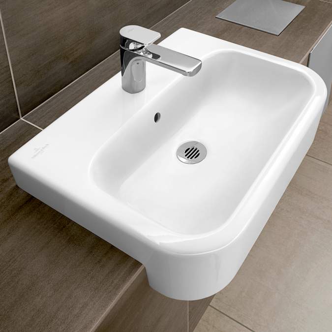 White sink basin on a wood effect counter by Villeroy & Boch