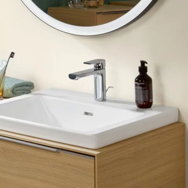 White sink basin on a wood effect counter by Villeroy & Boch