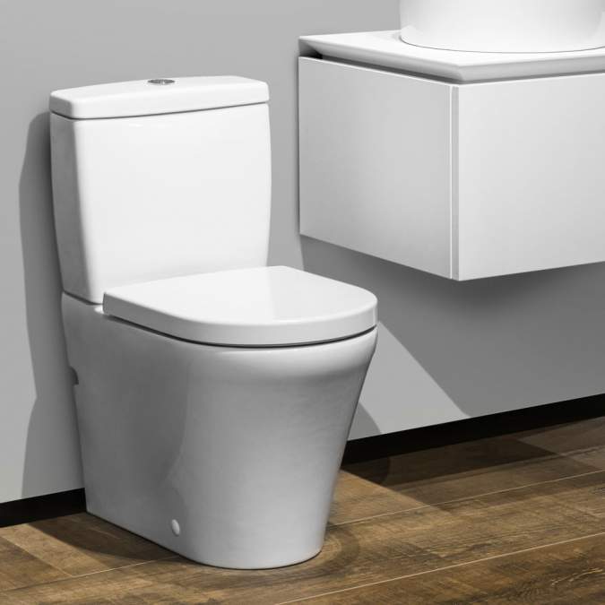 White toilet bowl and cistern, with freehanging white storage unit by Villeroy & Boch